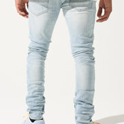 Light blue jeans worn by a person on a white background