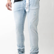 Light blue jeans with brand logo worn by a person on a white background