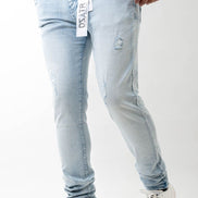 Light blue jeans worn by a person on a white background
