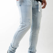 Light blue jeans worn by a person on a white background