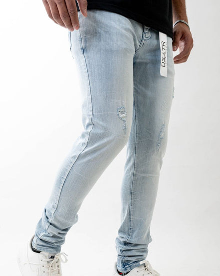 Light blue jeans worn by a person on a white background