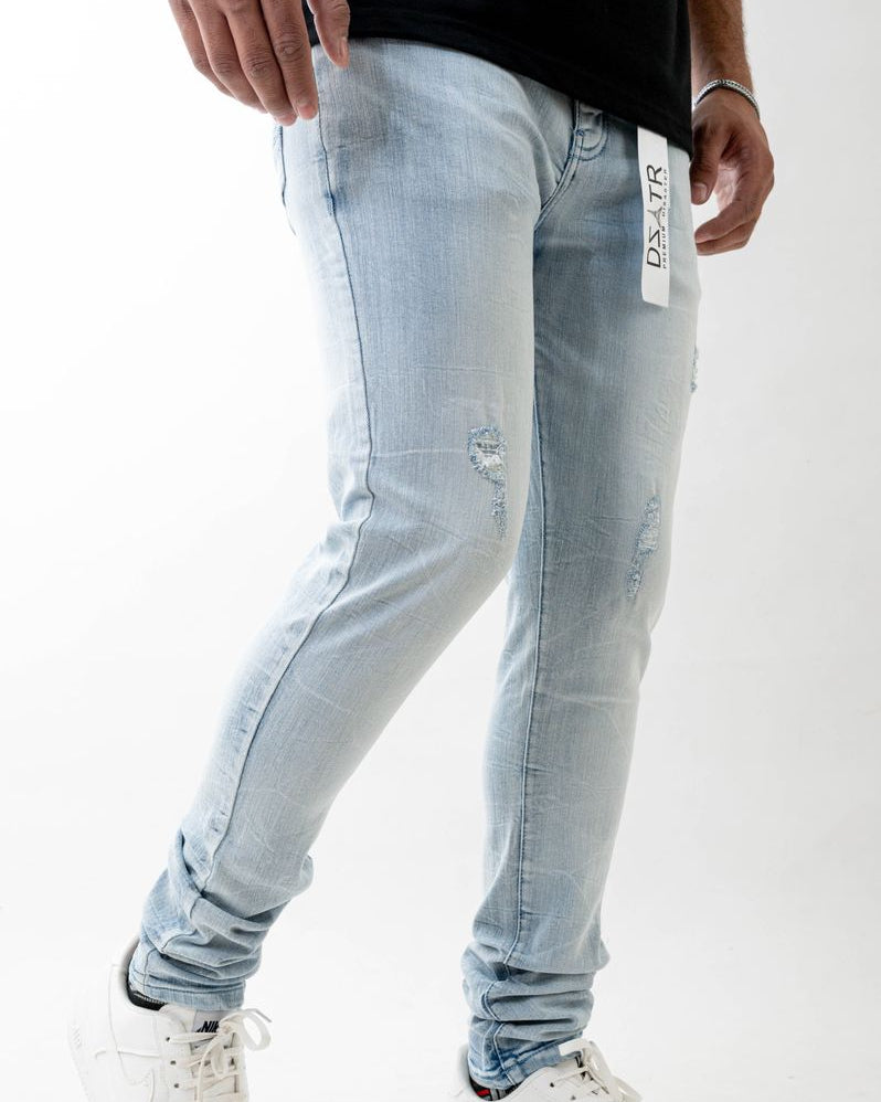 Light blue jeans worn by a person on a white background