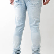 Light blue jeans worn by a person on a white background