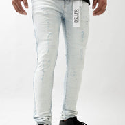 Person wearing light blue distressed jeans with a visible brand label on a white background