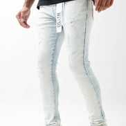 Person wearing light blue jeans with a brand logo on a white background