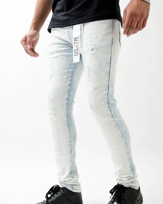 Person wearing light blue jeans with a brand logo on a white background