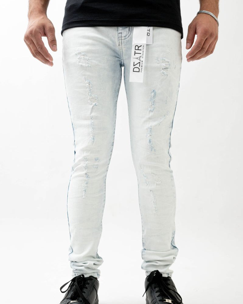 Person wearing light blue jeans with a brand label on a white background