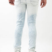 Person wearing light blue distressed jeans on a white background