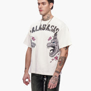 Man wearing a white t-shirt with graphic designs and text, standing against a white background