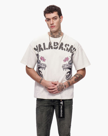Person wearing a white t-shirt with graphic designs and text, standing against a white background