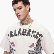 Man wearing a white t-shirt with graphic designs and text