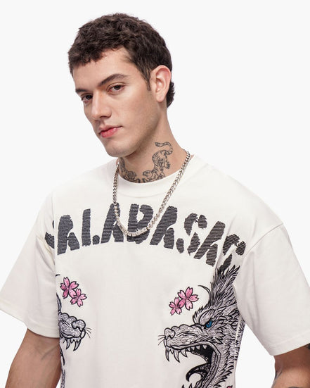 Man wearing a white t-shirt with graphic designs and text