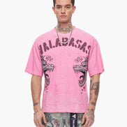 Person wearing a pink t-shirt with 'Valabash' branding and dragon design on a white background