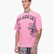 Person wearing a pink t-shirt with graphic designs and text on a white background