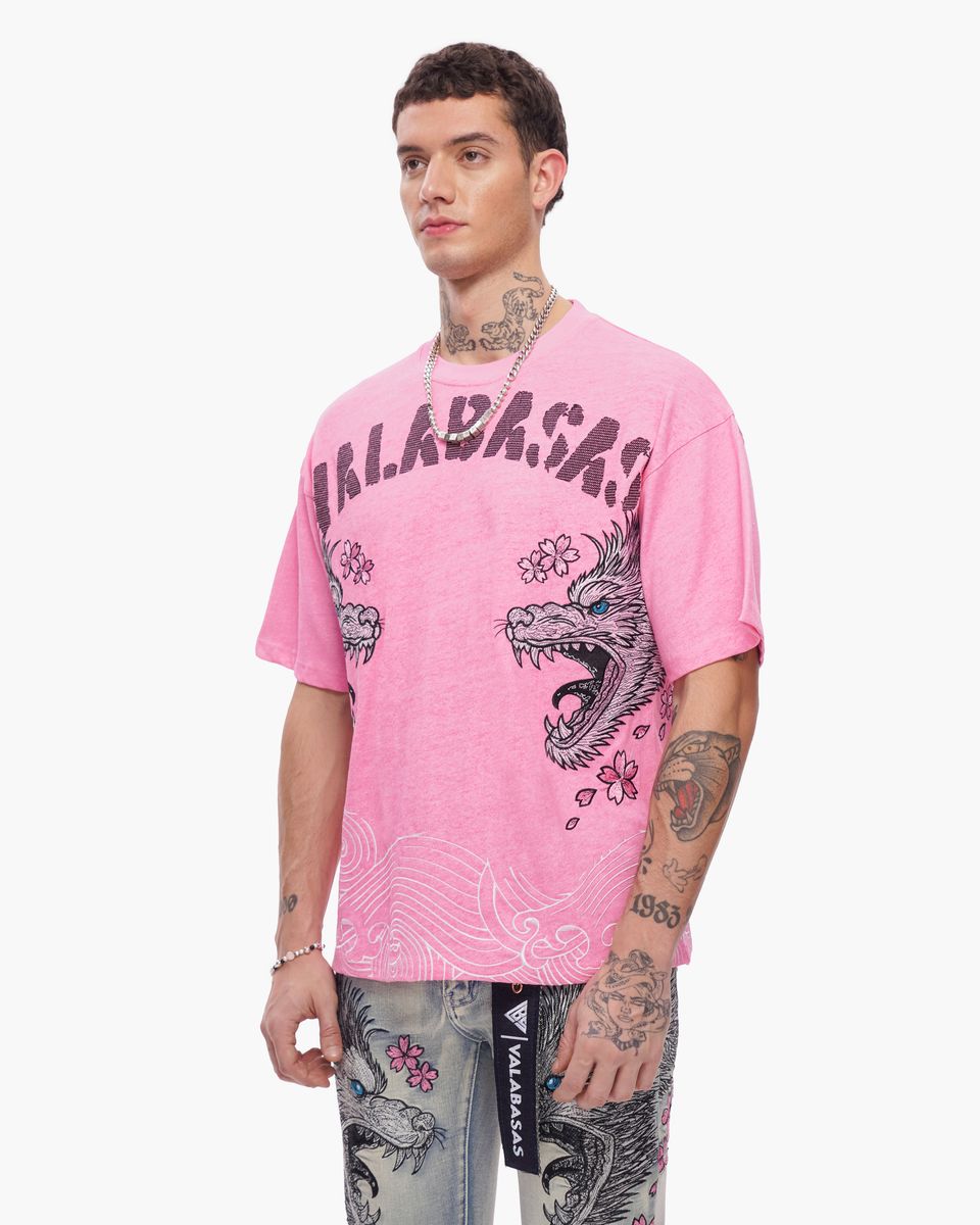 Person wearing a pink t-shirt with graphic designs and text on a white background