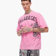 Person wearing a pink t-shirt with brand logo and graphic design on a white background