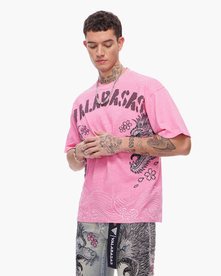 Person wearing a pink t-shirt with brand logo and graphic design on a white background