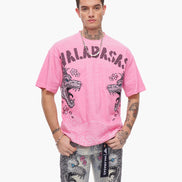 Person wearing a pink t-shirt with graphic designs on a white background