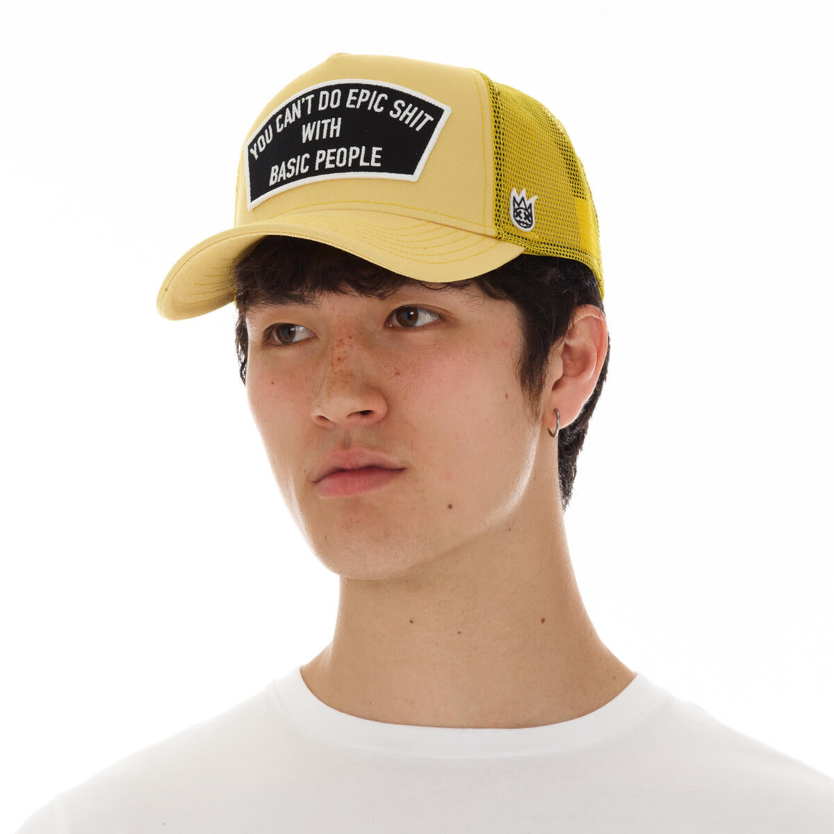Side view of the vintage yellow trucker hat displaying the details on the side.