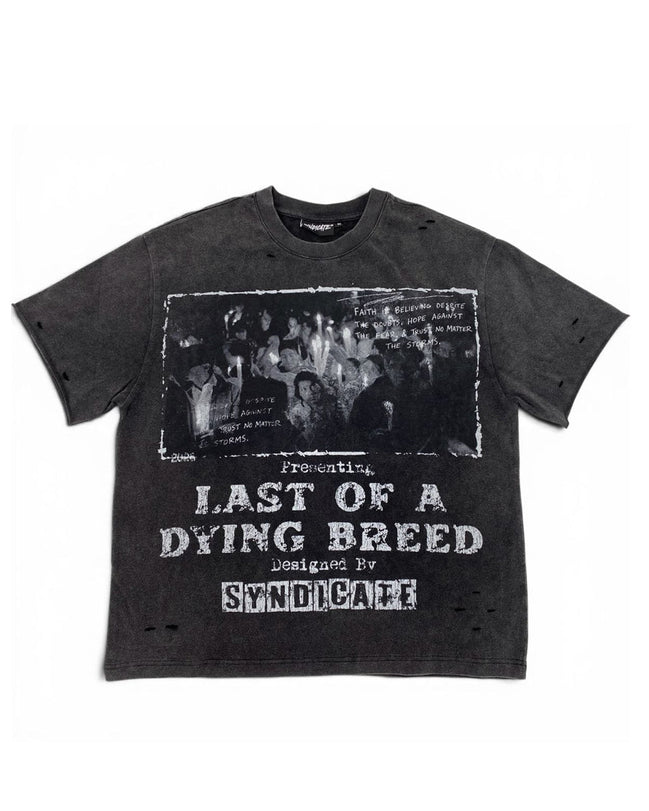A dark gray washed graphic t-shirt featuring a black-and-white band photo and distressed white text reading 'Presenting Last of a Dying Breed' and 'Designed by Syndicare'.