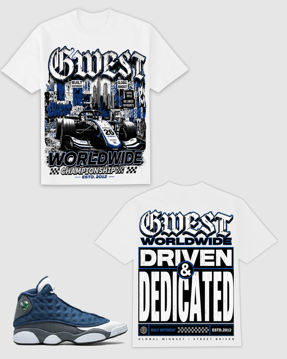 White graphic t-shirt shown from both front and back, featuring a blue and black race car design with 'Guest Worldwide Championship' on the front and large 'Driven & Dedicated' text on the back. A blue and white sneaker is pictured at the bottom left on a light gray background.