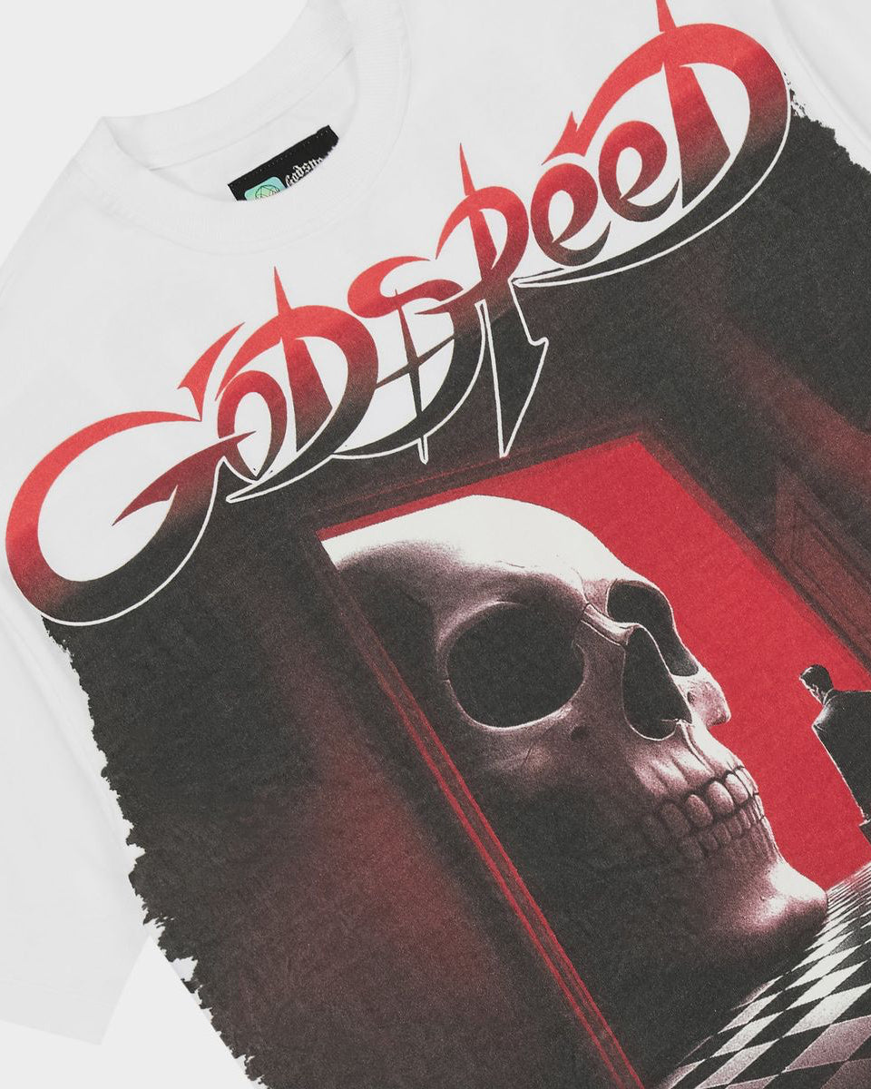 A close-up of a white t-shirt featuring a large graphic print of the band Godspeed. The graphic displays the band's name in stylized red and white lettering above a surreal scene of a large skull in a doorway with a figure standing in the foreground.