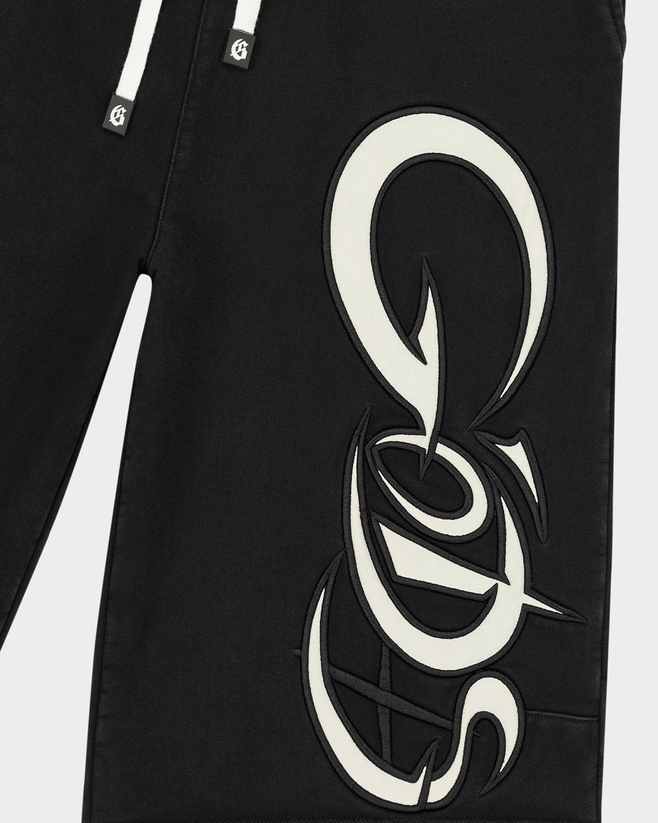 Black pants with a large white logo on a white background