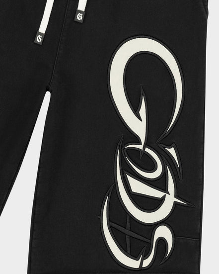 Black pants with a large white logo on a white background