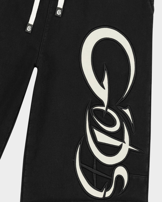 Black pants with a large white logo on a white background