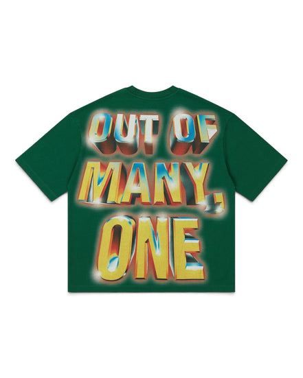 A dark green short-sleeve t-shirt with a large, colorful graphic text print reading 'OUT OF MANY, ONE' in a 3D metallic yellow, blue, and red gradient style, displayed flat against a white background.