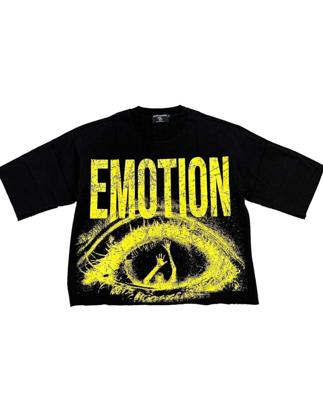 front view of trapped cropped shirt in black with the yellow graphic of an eye. 