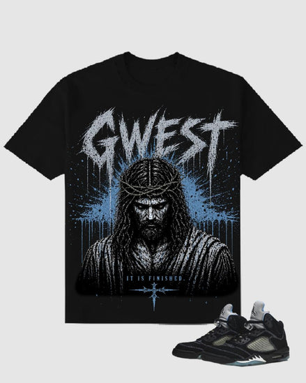 Black t-shirt with graphic design and text, paired with a black sneaker on a light gray background
