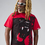 Person wearing a red t-shirt with a black panther graphic on a gray background