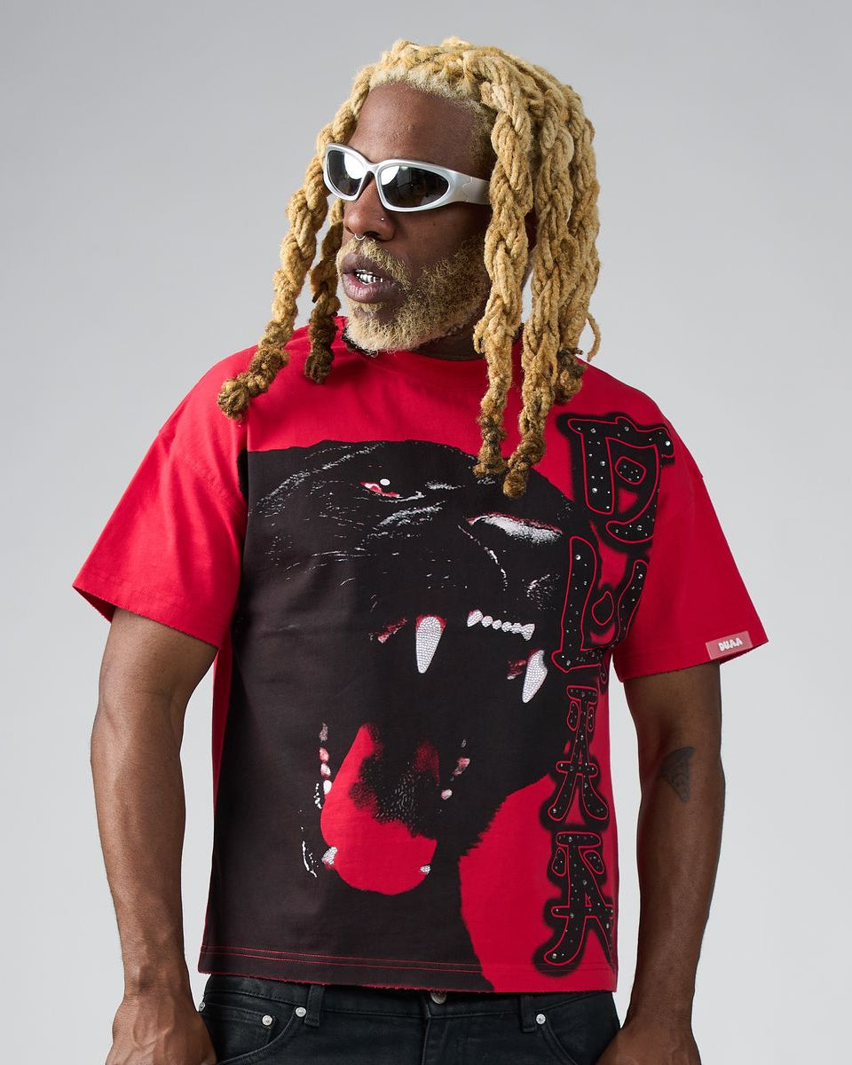 Person wearing a red t-shirt with a black panther graphic on a gray background