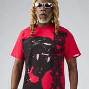 Person wearing a red t-shirt with a black panther graphic and text on a gray background