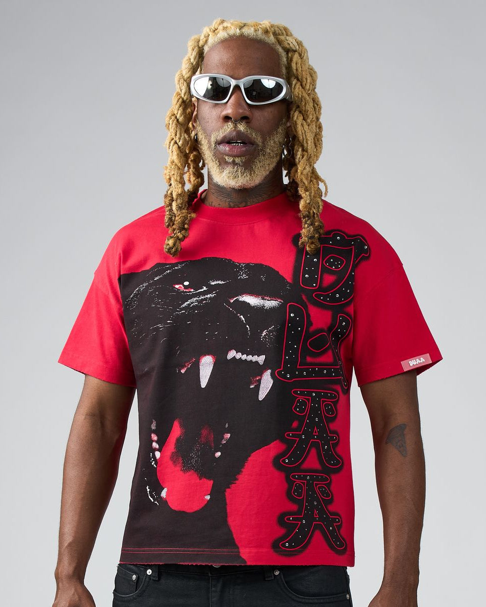 Person wearing a red t-shirt with a black panther graphic and text on a gray background