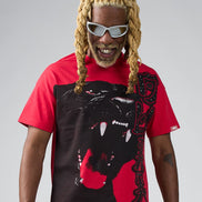 Person wearing a red and black graphic t-shirt with a panther design on a gray background