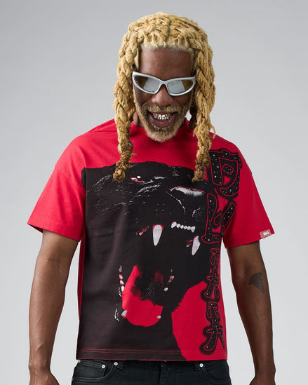 Person wearing a red and black graphic t-shirt with a panther design on a gray background