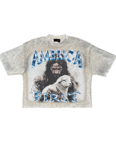 KHAKI t-shirt with graphic design of a man and lamb with 'AMERICA FIRST' text on a white background