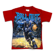 A red short-sleeve graphic t-shirt featuring a large front print of a basketball player in a blue uniform dribbling a basketball on a court, with the text 'BALL OUT' in blue above the graphic.