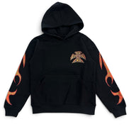 A black pullover hoodie featuring a small gothic-style cross emblem on the left chest and orange flame graphics running down both sleeves, displayed against a solid white background.