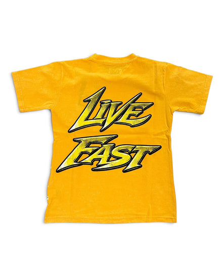 A yellow short-sleeve t-shirt with a large graphic print on the front reading 'LIVE FAST' in a stylized yellow and black font, shown against a plain white background.