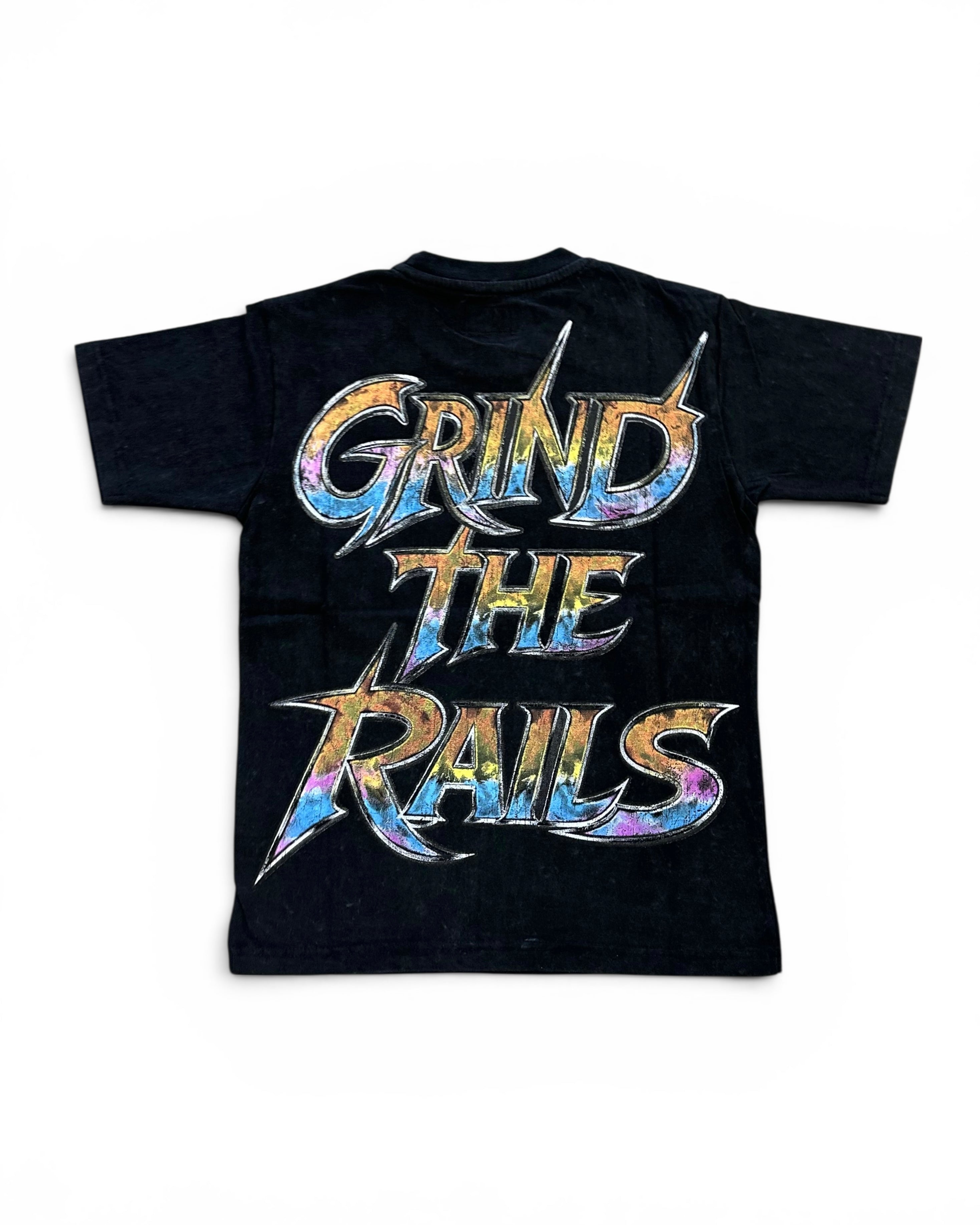 A black short-sleeve t-shirt with a large graphic on the back reading 'GRIND THE RAILS' in stylized metallic lettering with a blue, purple, and orange tie-dye pattern, shown on a plain white background.