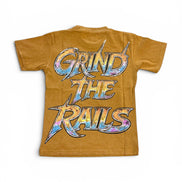 A mustard yellow short-sleeve t-shirt with a large graphic on the back reading 'GRIND THE RAILS' in stylized metallic letters with a blue, purple, and orange tie-dye pattern.