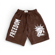 Brown shorts with 'FREEDOM' text and a graphic design on a white background