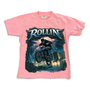 A pink short-sleeve graphic t-shirt featuring a large front print of a mountain biker with the word 'ROLLIN' in stylized blue and white lettering above, set against a plain white background.