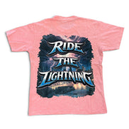 A pink short-sleeve t-shirt with a large graphic print on the back featuring the text 'RIDE THE LIGHTNING' in stylized blue and white lettering over a dark stormy background.