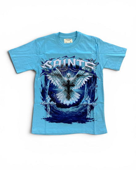 A light blue short-sleeve graphic t-shirt featuring a large front print of a white angel with wings and a cross, with the word 'SAINTS' in stylized white lettering above, on a white background.