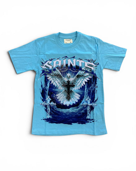 A light blue short-sleeve graphic t-shirt featuring a large front print of a white angel with wings and a cross, with the word 'SAINTS' in stylized white lettering above, on a white background.
