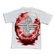 A white short-sleeve t-shirt featuring a large graphic print on the front. The design shows a metallic silver cross inside a circular red and black textured background, with the word 'SAINTS' printed below in red and silver.